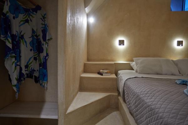 A blue and white floral print bed in a charming cellar accommodation in oia santorini hu f19b908dce072de8.jpg