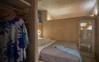 A cozy bedroom in a cellar in oia santorini featuring a bed and a closet for comfortable accommodation hu fd040c9a69631e31.jpg