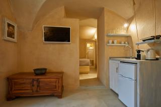 A cozy kitchen in a santorini cellar featuring a sink and a small table perfect for intimate meals hu7825944079201253742.jpg