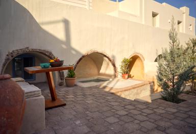 A patio featuring a table and a bench creating a cozy outdoor seating area for relaxation and gatherings.jpg