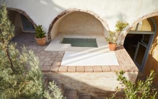 A small pool nestled in a courtyard of a converted cellar in oia santorini offering a serene retreat hu6881469705940482749.jpg