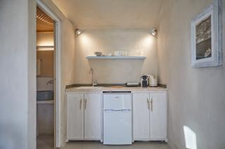 A compact kitchen featuring a sink and a refrigerator showcasing efficient use of space and essential appliances hu f7b0421236f243ed.jpg