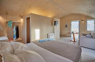 A cozy bedroom featuring a bed a television and a desk for work or study hu 62b28df59a49e7d.jpg