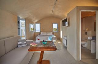 A cozy bedroom featuring a comfortable couch a neatly made bed and a stylish table hu 9eda193abf68a42a.jpg