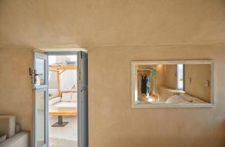 A cozy room featuring a neatly made bed and a stylish mirror reflecting the serene atmosphere hu 371689a2ebe998c2.jpg