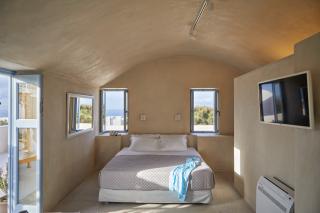 A serene bedroom featuring a bed and a window that offers a stunning view of the ocean hu5624878040196626503.jpg