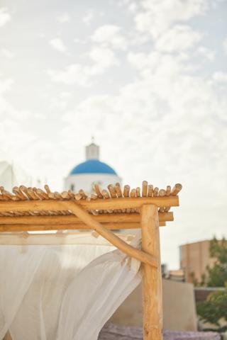 A wooden canopy draped with white sheets creating a serene and elegant outdoor space hu f0146f7e730fcf2d.jpg