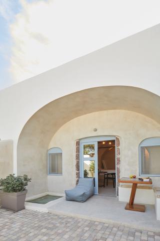 A charming patio in oia santorini complete with a table and chairs as well as a private hot tub and courtyard for unwinding hu14224670625439997810.jpg