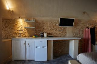 A cozy kitchen featuring a sink and microwave part of a cellar accommodation in oia santorini with a private hot tub hu15731551095855399823.jpg